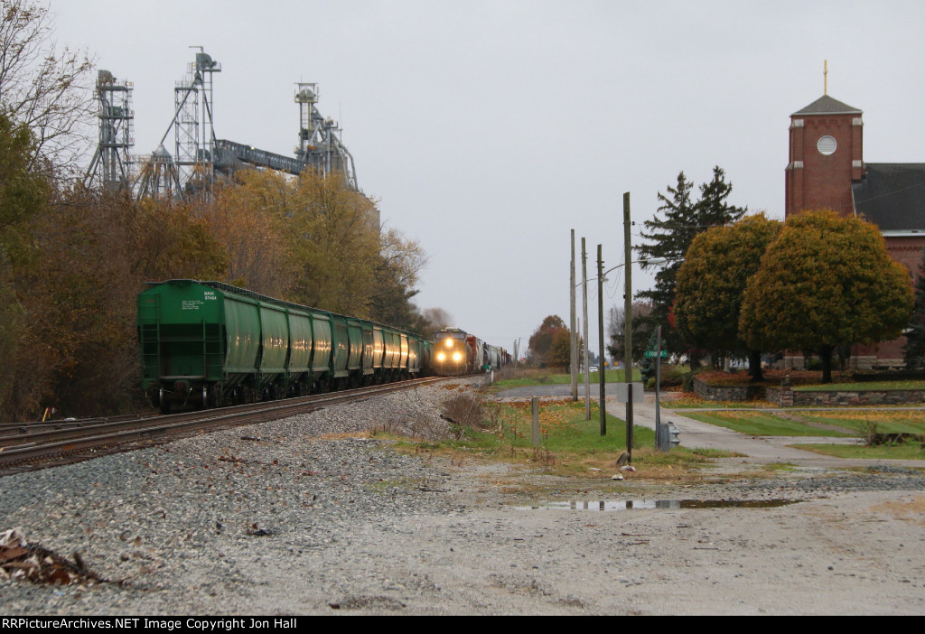 Passing a cut of TPW interchange cars in the siding, Q642 comes north on the old Monon